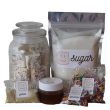 Load image into Gallery viewer, ingredients in the marshmallow making kit, bag of sugar, jar of honey, packs of gelatin and sprinkles 