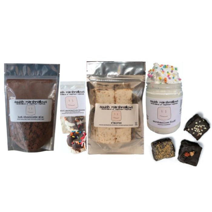Comfort Kit displayed with a pack of hot chocolate mix, a box of mini marshmallow donuts, a 6-pack bag of marshmallows, a jar of marshmallow fluff, and 3 chocolate dipped marshmallows.