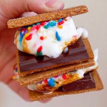 Load image into Gallery viewer, 2 assembled s&#39;mores made of graham crackers, birthday party marshmallows, and chocolate