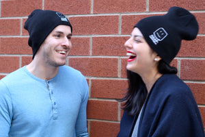 Male and female models wearing the beanies, smiling 