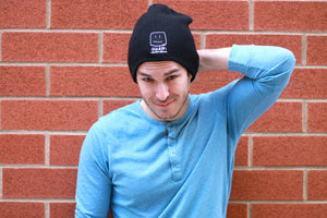Male model wearing the beanie, smiling 